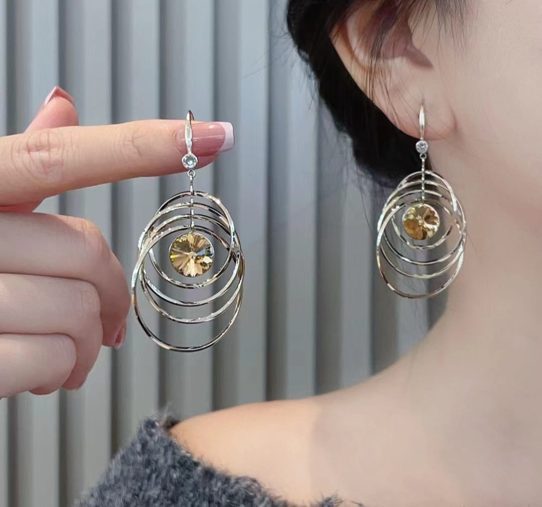 Kinetic Concentric Hoop Drop Earrings with Bright Orange Crystal Center