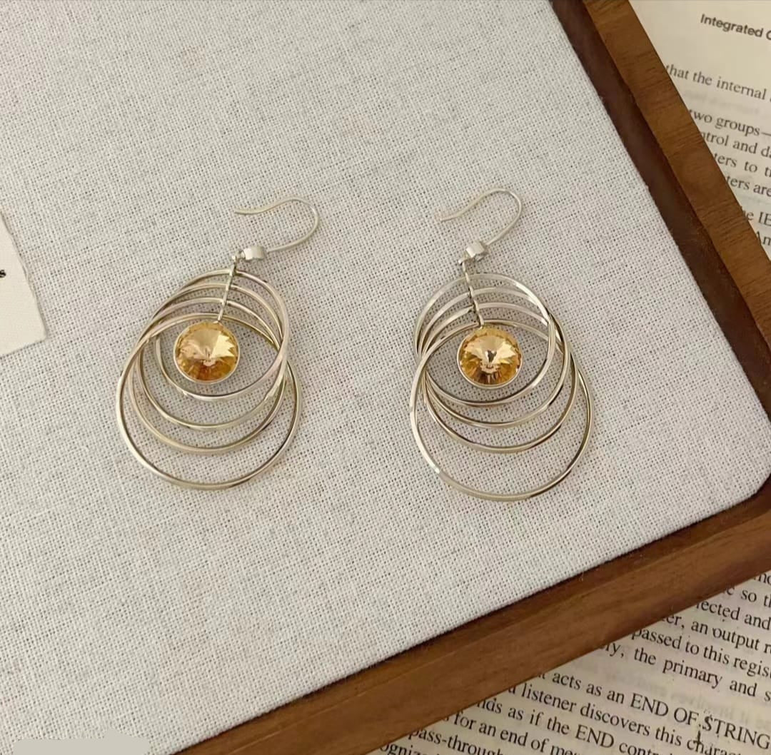 Kinetic Concentric Hoop Drop Earrings with Bright Orange Crystal Center