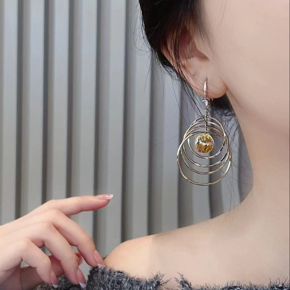 Kinetic Concentric Hoop Drop Earrings with Bright Orange Crystal Center